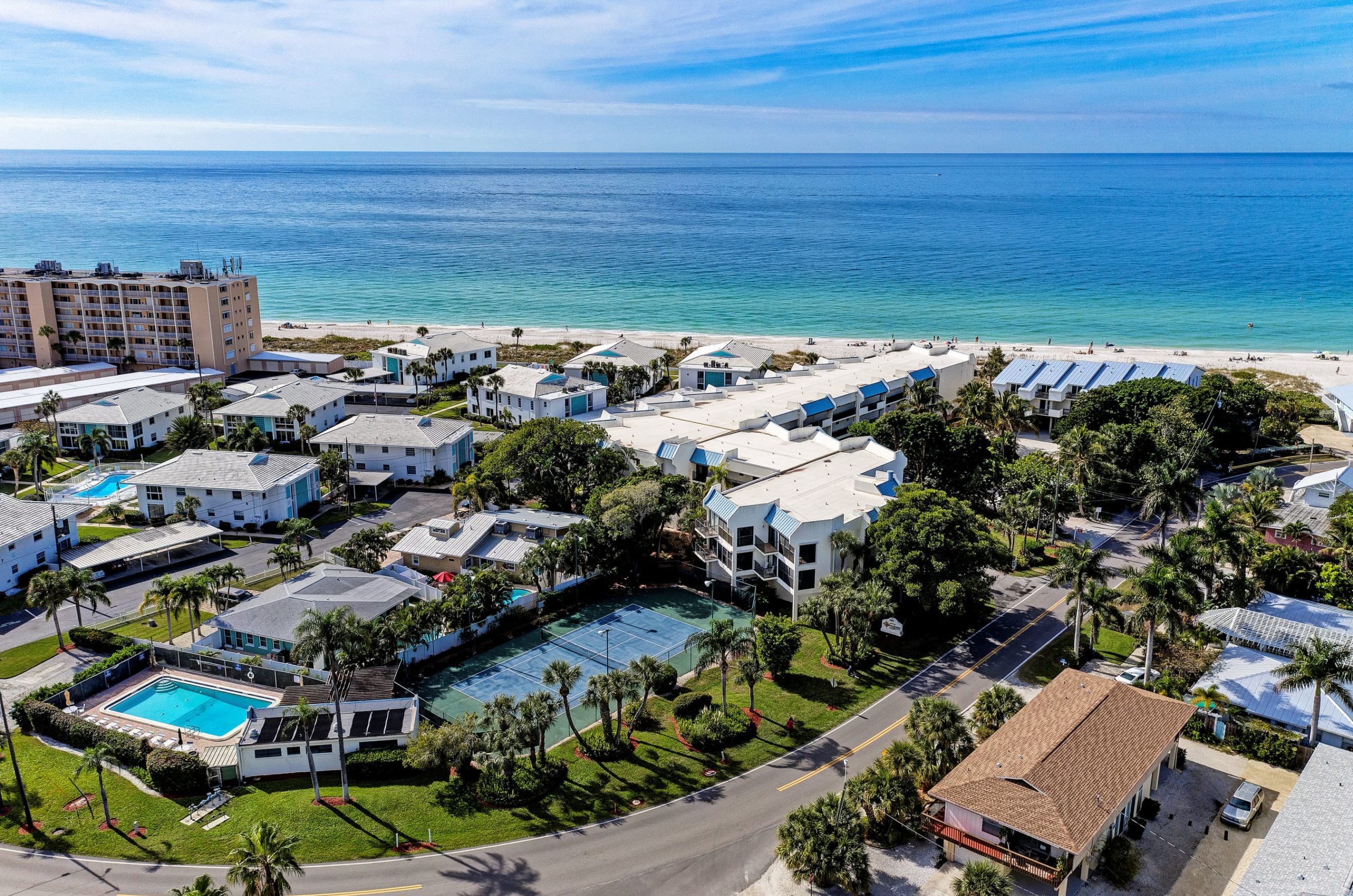aerial view overlooking many different condo buildings with the Gulf of Mexico in the background on a bright, sunny day in Holmes Beach on Anna Maria Island