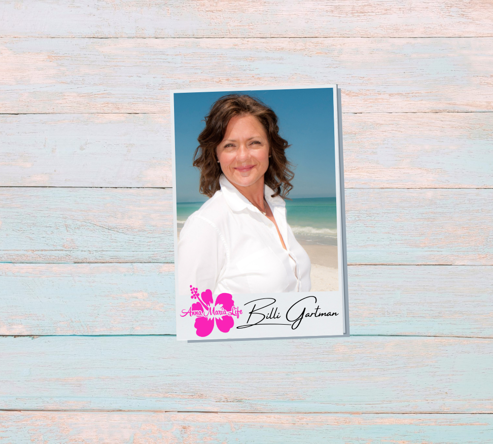 woman with brown hair and white shirt on the beach: Billi Gartman, Owner of Anna Maria Life Vacation Rentals