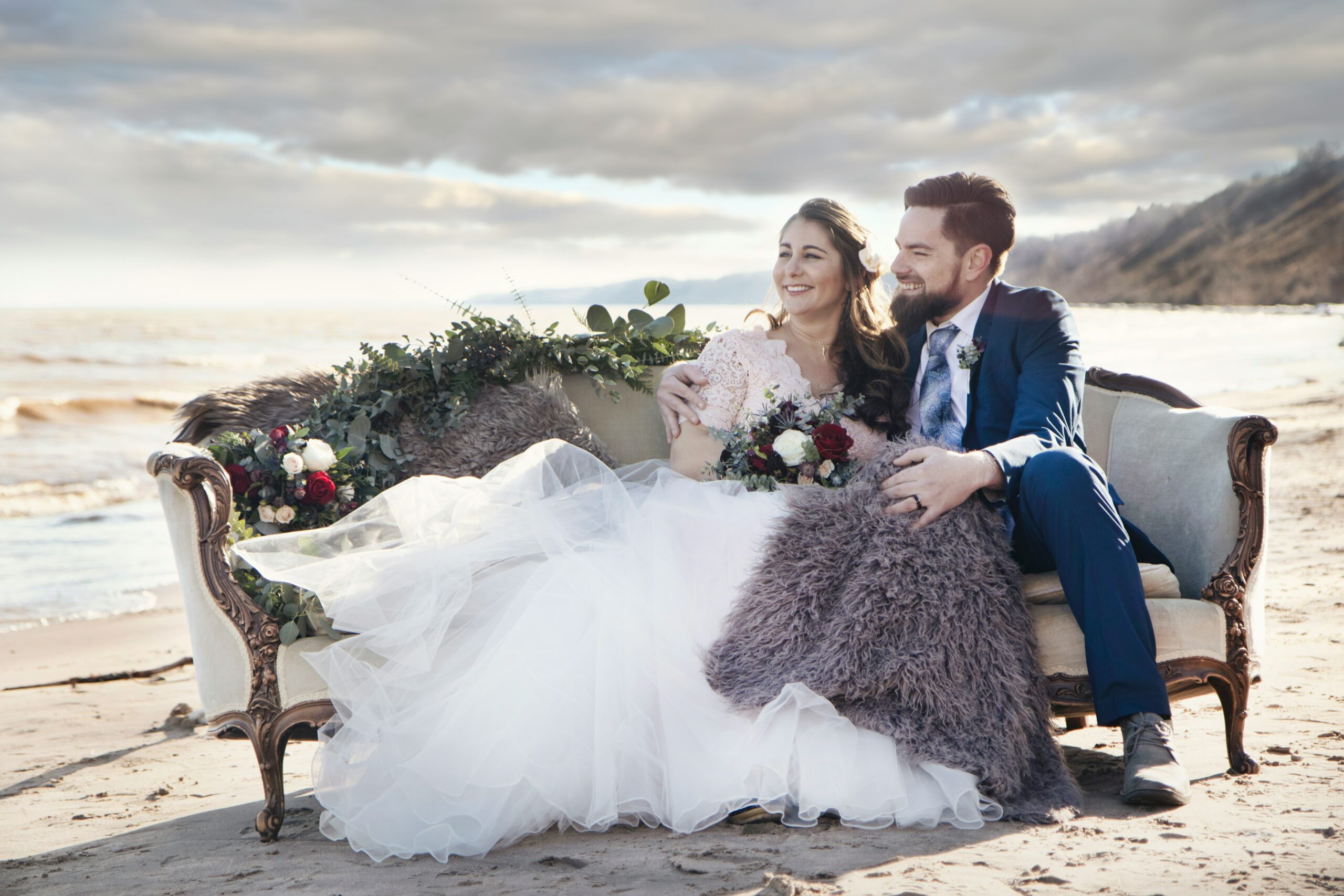Newlyweds sitting beachside in Anna Maria island