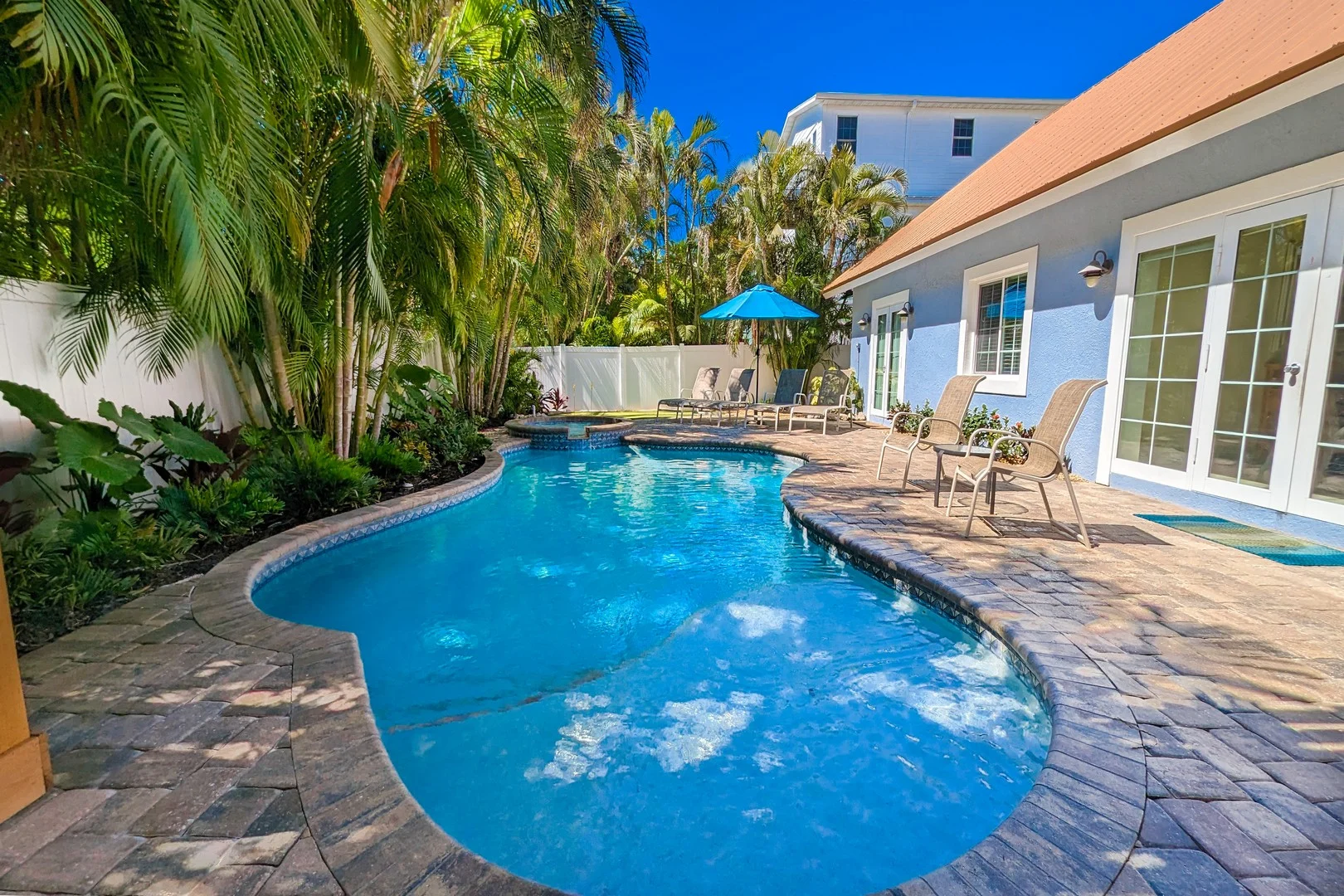 Pool in yard with palm trees